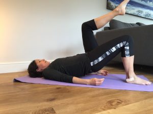 picture of pilates bridge with knee fold to test running technique