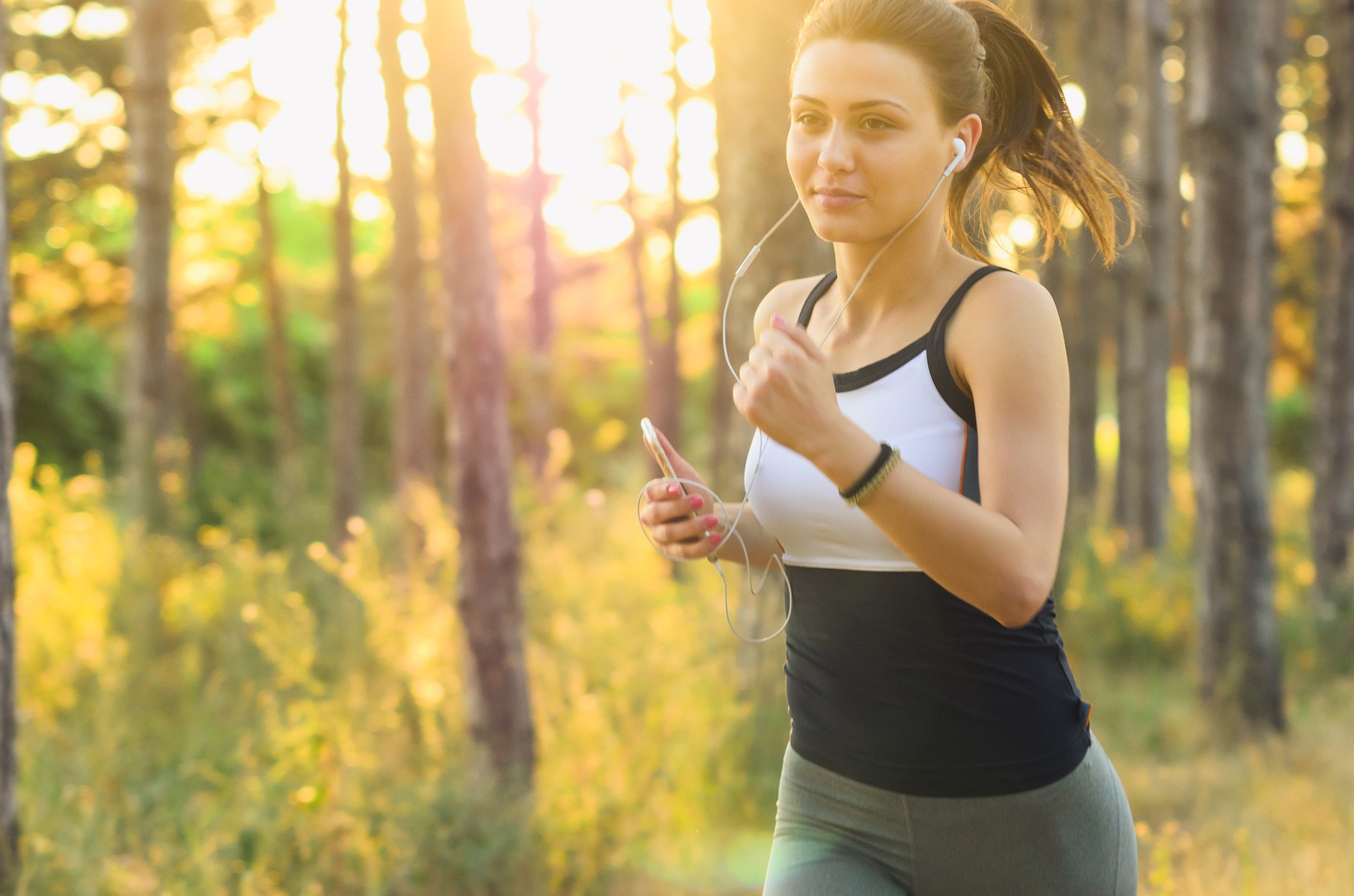 picture of a woman running with earphones